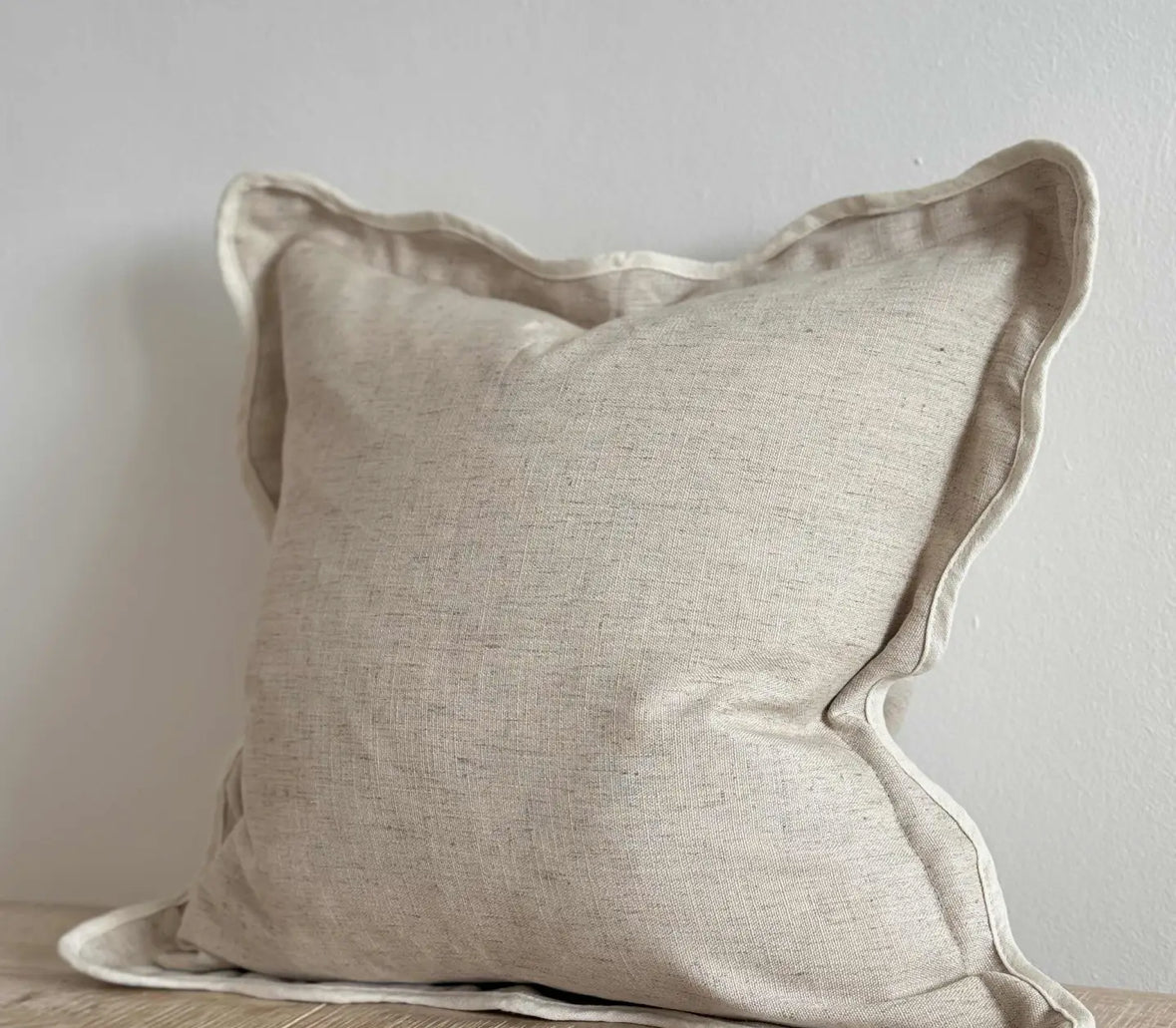 Scalloped neutral linen cushion
