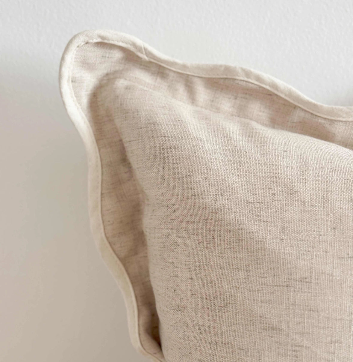 Scalloped neutral linen cushion