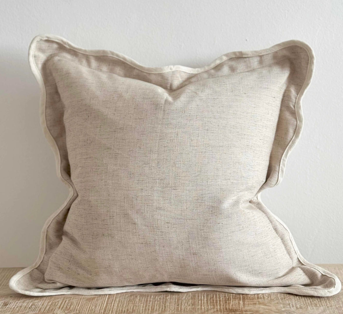 Scalloped neutral linen cushion